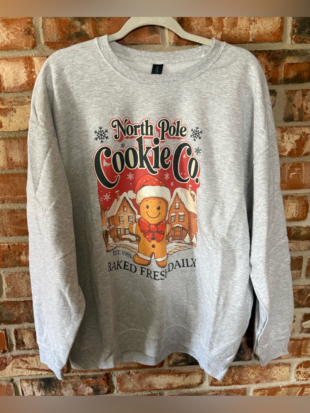 Gildan Light Gray Sweatshirt with North Pole Cookie Co Gingerbread Graphic